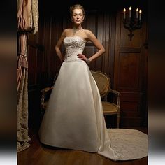 a woman in a wedding dress standing next to a chair