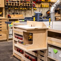 a workbench with tools in it and lots of woodwork on the shelves