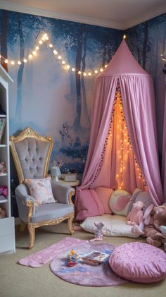 a pink canopy bed in a girls'bedroom with fairy lights on the walls and floor