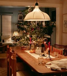 a dining room table is set for christmas dinner