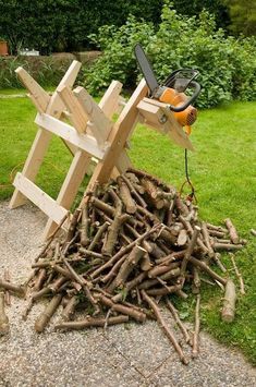 a pile of wood with a pair of scissors on top of it next to some branches