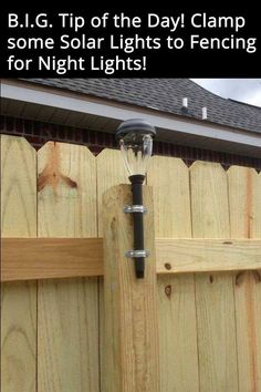 a light on top of a wooden fence next to a house with the caption b i g tip of the day clamp some solar lights to fencing for night lights