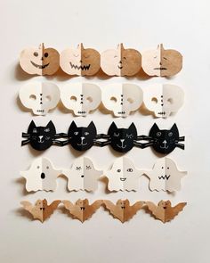 a bunch of wooden cut outs with cats and bats attached to the sides of them