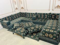 an ornate couch with several pillows on it