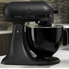 a black mixer sitting on top of a counter