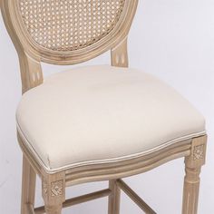 an upholstered stool with a cushion on it's seat and backrest