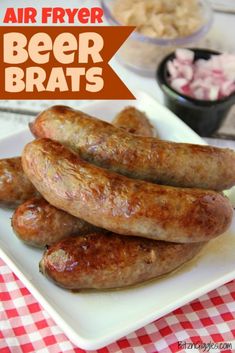 some sausages are on a white plate with red and white checkered tablecloth