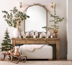 a living room decorated for christmas with trees and decorations on the table, along with a mirror