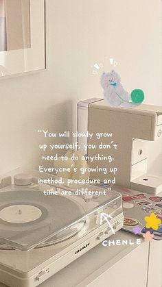 a record player sitting on top of a table next to a mirror and other items