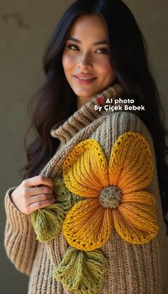 a woman wearing a sweater with a flower on it