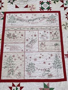 a quilted table runner with christmas designs on it