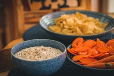 three bowls filled with food sitting on top of a table