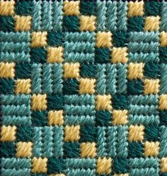 a close up view of a blue and yellow woven material with small squares on it