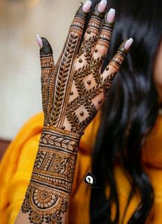 a woman's hand with henna on it