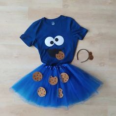 a blue dress with cookie cookies on it, and a cookie hat next to it