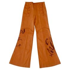 Vintage 1970s handmade North Beach Leather deerskin pants in a sailor-pant style, flared bell bottom fit. Whipstitch construction, 8-button front. Dragon art on both legs, signed "Gary". These are in good condition, especially for a pair of this age from North Beach Leather. The leather is incredibly soft and supple. There are what appears to be a small scratch near the center seam in the back, as well as a number of small marks and stains, shown in the photos. Tagged a size 8. Measurements are Mexican Rodeo, The Shining Twins, Sailor Pants, Jean Vintage, North Beach, Couture Vintage, Deer Skin, Pant Style, Bell Bottom