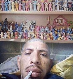 a man with his tongue out in front of a shelf full of toy figurines