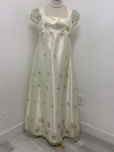 Beautiful light green organza over cream satin dress, perfect for that regency Era party or event . THERE IS NO RETURNS OR EXCHANGES ACCEPTED PLEASE BE SURE TO CHECK THE MEASUREMENTS ON THE BOTTOM OF THE DESCRIPTION. If for any reason the measurements don't match with yours be sure to provide to me at the time of order. SMALL / BUST / Length 34-36. 45 MED / 37-38. 46 LARGE /. 40/42. 47 The small dress is made with a size 10 pattern , the medium with a size 12 and the large with a size 14 . I DO Regency Debutante Dress, Spring Silk Gown With Fitted Bodice, Spring Satin Ball Gown, Spring Party Empire Waist Gown, Spring Party Gown With Empire Waist, Empire Waist Gown For Spring Party, Spring A-line Silk Gown, Regency Style Evening Dress For Spring, White Spring Festive Gown