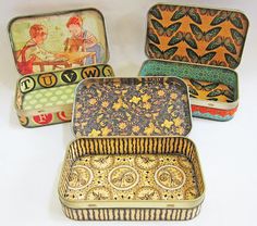 four tins with different designs on them