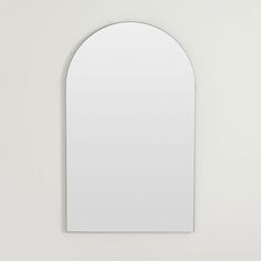 an arched mirror mounted on the wall