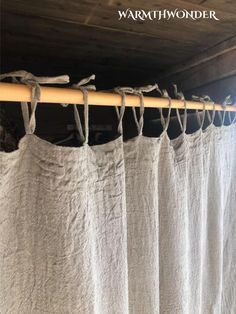 a curtain is hanging on a wooden rod