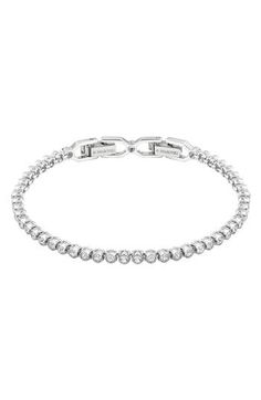 Bezel set crystals line up to stream shine all around this delicate, light-catching bracelet. 6 7/8" length Fold-over clasp Rhodium plate/Swarovski crystal Imported Formal Adjustable Crystal Tennis Bracelet, Birthday Fits, Swarovski Ring, Classic Bracelets, Pretty Necklaces, Womens Designer Fashion, Sparkling Crystal, Diamond Bracelets, Tennis Bracelet