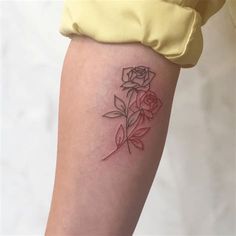 a woman's thigh with a rose tattoo on it