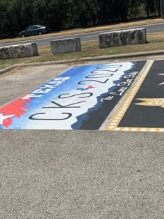 a parking lot with an american flag and stars painted on the ground in front of it