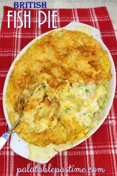 a casserole dish on a red and white checkered tablecloth with a spoon in it