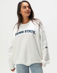 Hype And Vice Penn State University Crewneck Sweatshirt. Applique Lettering At Chest. Embroidered Logo Patch At Left Sleeve. Side Seam Hand Pockets. Ribbed Crew Neckline. Cuffed Long Sleeves And Hem. Fleece Lining. 50% Cotton 49.8% Polyester 0.2% Viscose. Hand Wash. Imported. Model Is Wearing A Size Small. Model Measurements:height: 5'7" Bust: 34"waist: 25"hips: 34.5" College Crewneck, Cute College Merch, Varsity Tops With Embroidered Logo For Fall, Embroidered Graphic Tops For College In Fall, Fall College Top With Embroidered Graphics, Embroidered Fall College Top, Embroidered Tops For College In Fall, Varsity Tops With Embroidered Graphics For Campus, Varsity Tops With Embroidered Logo For Campus