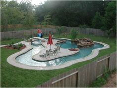 a backyard with a pool and fire pit