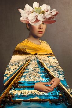 a woman with flowers on her head and train tracks in front of her, as if she was floating