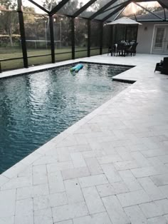 a swimming pool with an enclosed patio area