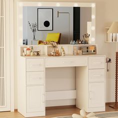 a white vanity with lights on it in a room next to a mirror and lamp