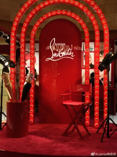 a red display with lights and chairs in front of it