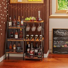 there are many bottles and glasses on the shelf next to the chalkboard that says menu