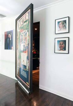 an open door leading into a room with pictures on the wall and wood flooring