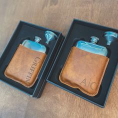 two leather flasks in a black box