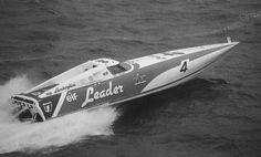 an old photo of a speed boat in the water