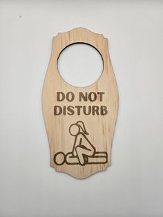 a wooden sign that says do not disturb with a person on a scooter