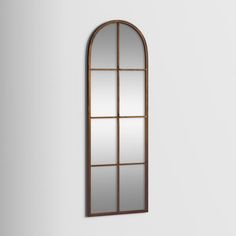 an arched mirror hanging on the wall