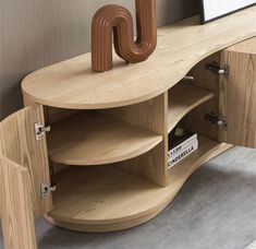 a wooden table with an unusual shaped object on it's shelf and bookshelf