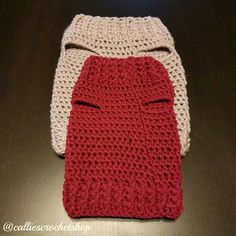 two crocheted bags sitting on top of a table