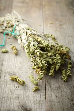 dried herbs on wooden table with string