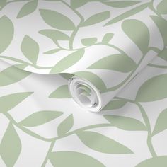 a green and white wallpaper with leaves on it