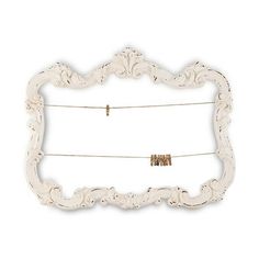 an ornate white frame with clothes pins hanging from it's sides, on a white background