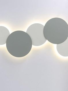 three circular lights mounted on the side of a wall