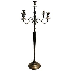 a metal candelabra with five candles on it