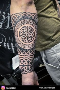 a man with a celtic tattoo on his arm