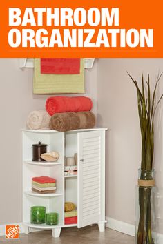 the bathroom organization book is open to show towels and other items on shelves in front of a plant